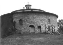 SA0741.20 - Photo of round barn, looking south.  Date stones over arched doorway.